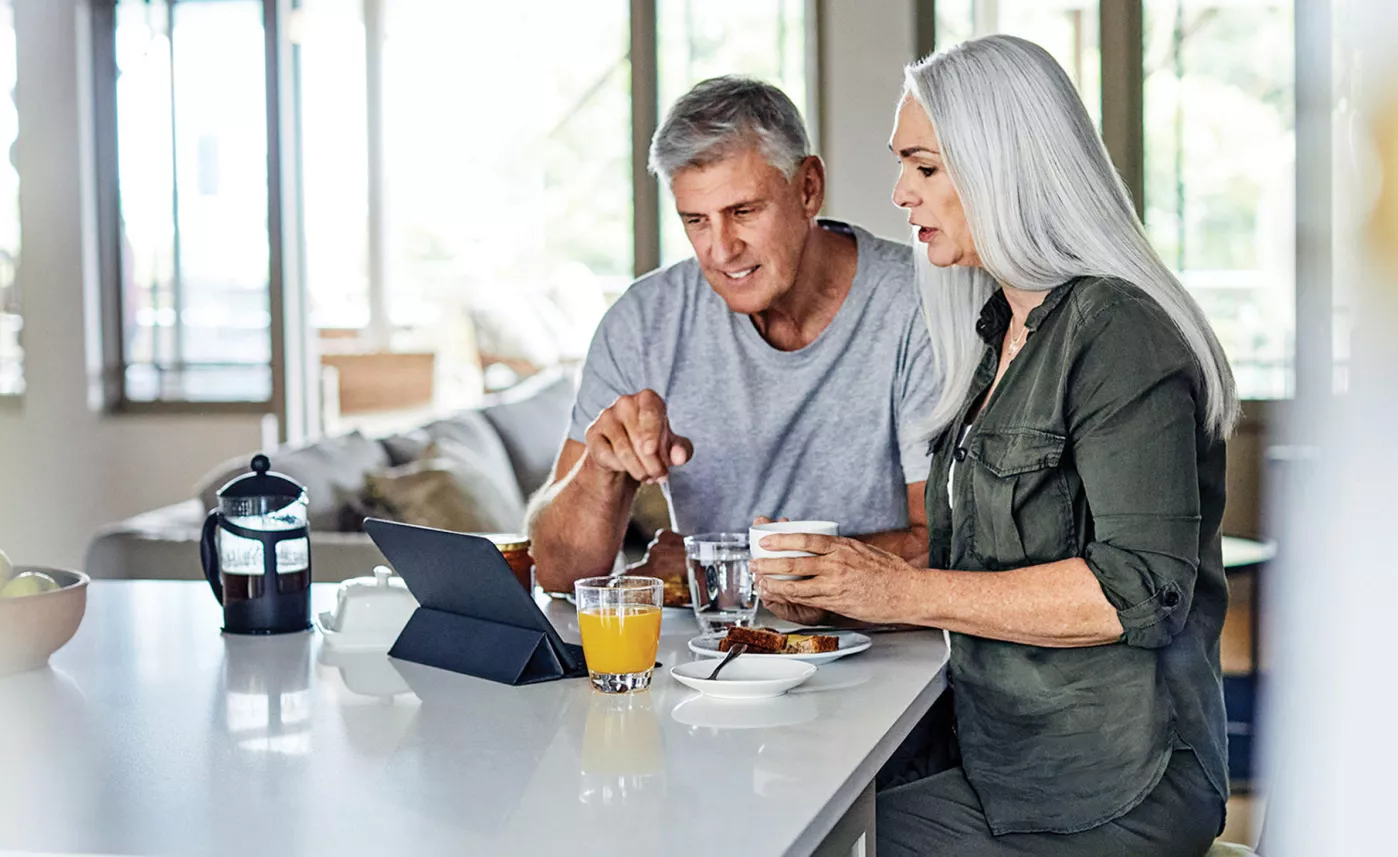  Man and woman having breakfast at kitchen counter
