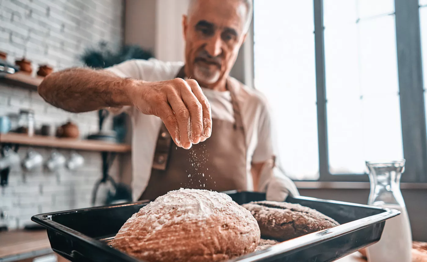  Man cooking in kitchen.

