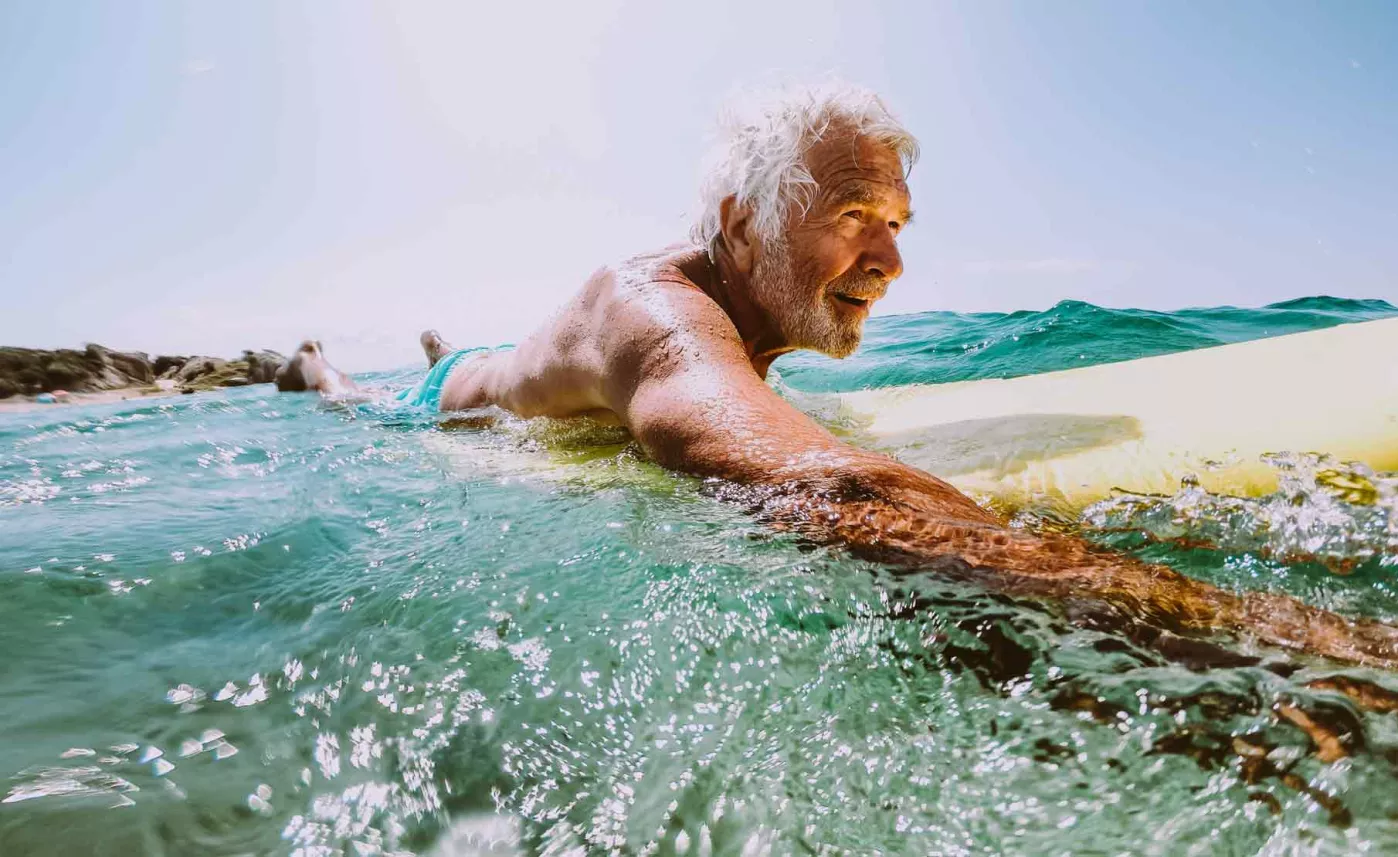  Older man with surfboard
