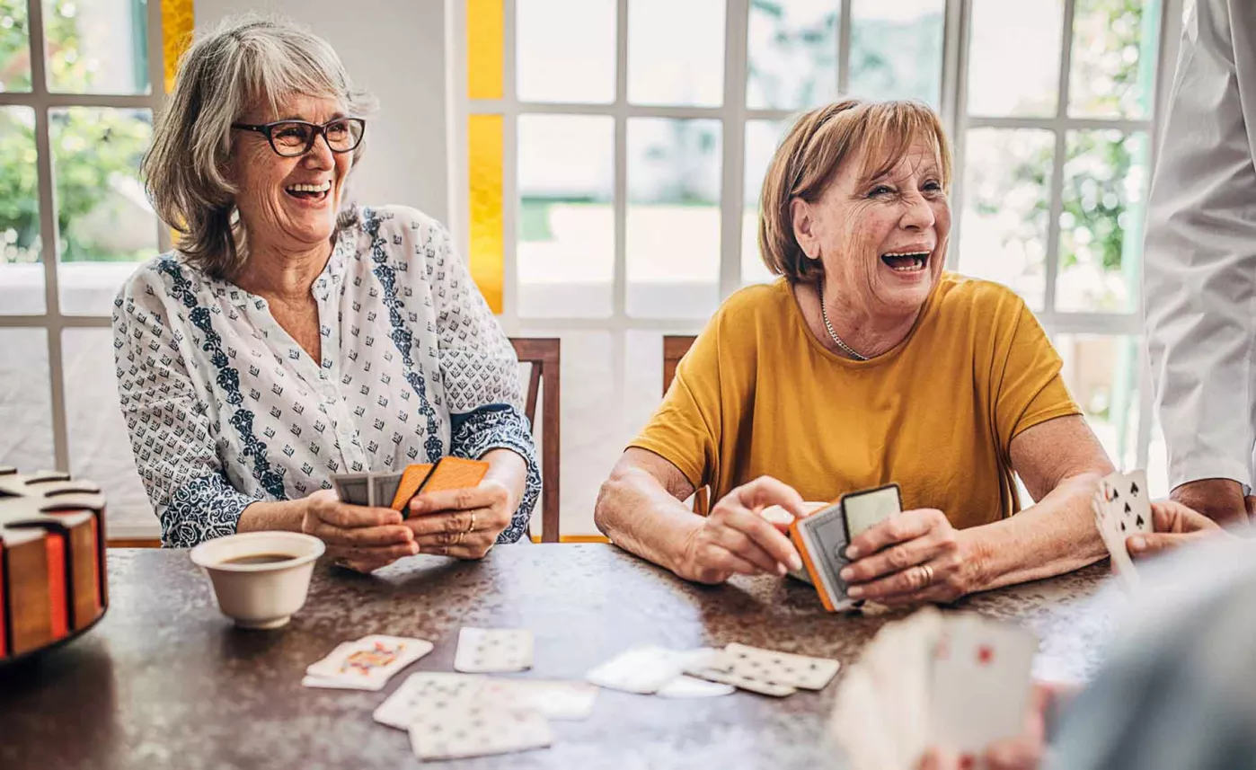  Retired woman enjoy while playing cards
