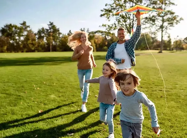  Couple running behind children with kite
