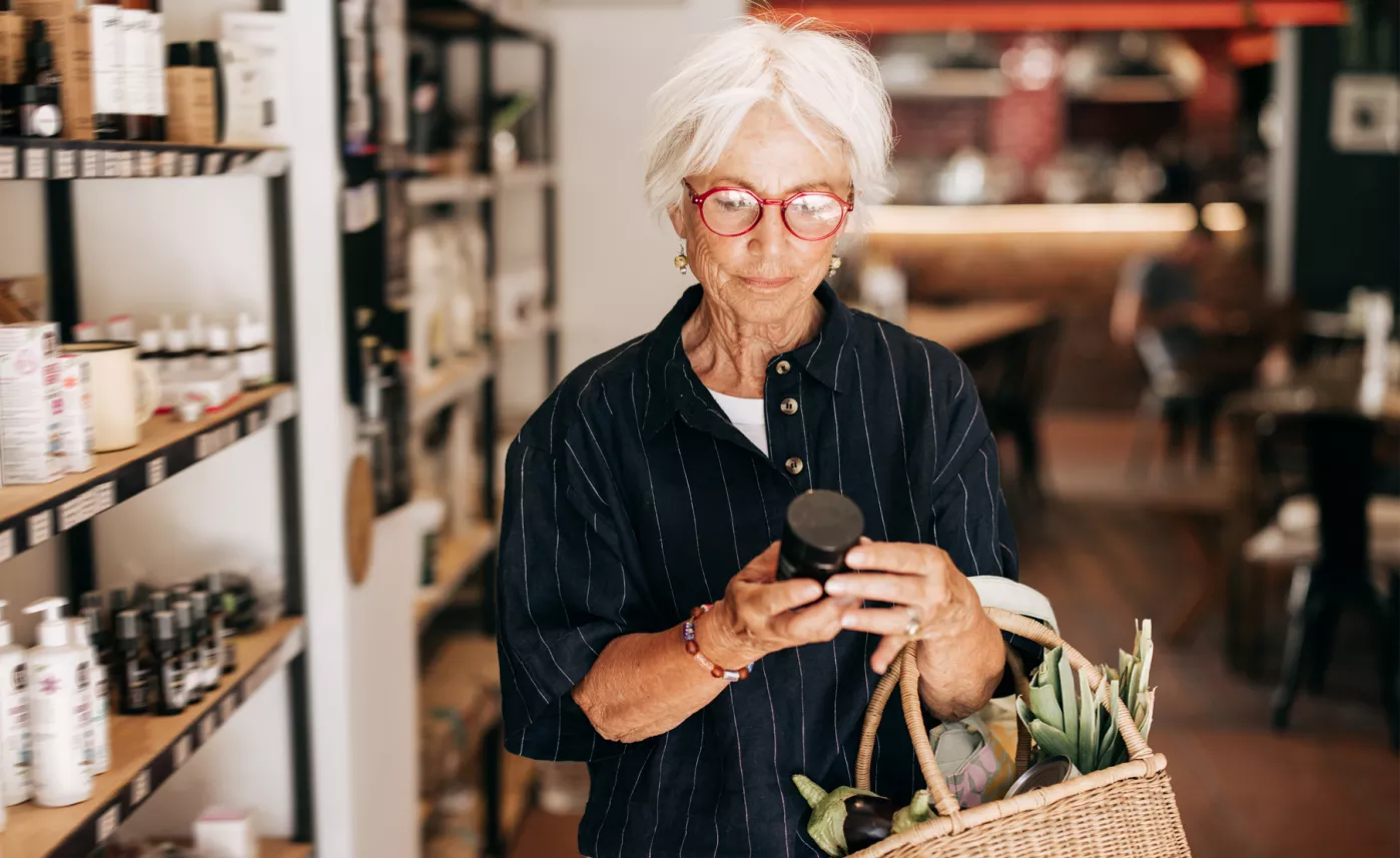  A retired woman purchasing some higher-end items at a local store
