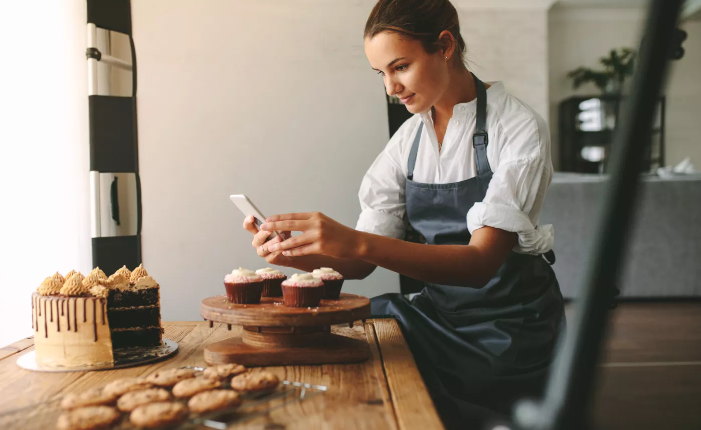  A young woman posting on social media in support of her small business
