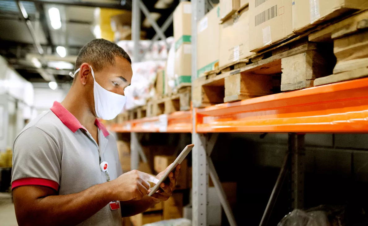 An employee of a small business checks records in a stockroom.
