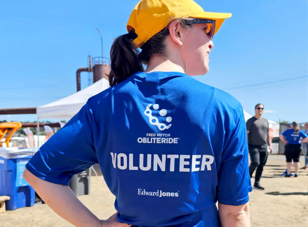  Woman wearing sunglasses, baseball cap and a volunteer tee shirt
