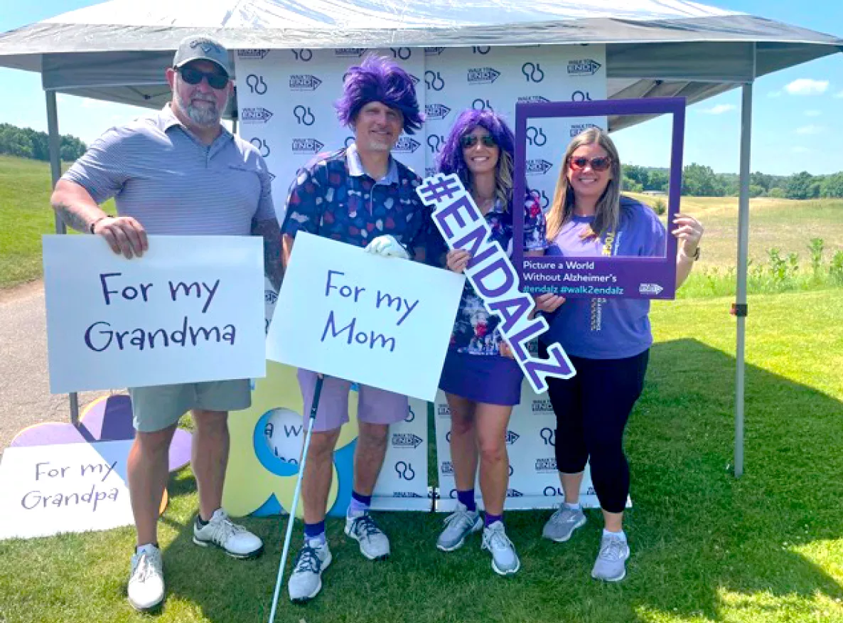  4 people holding signs to support Alzheimer's Association
