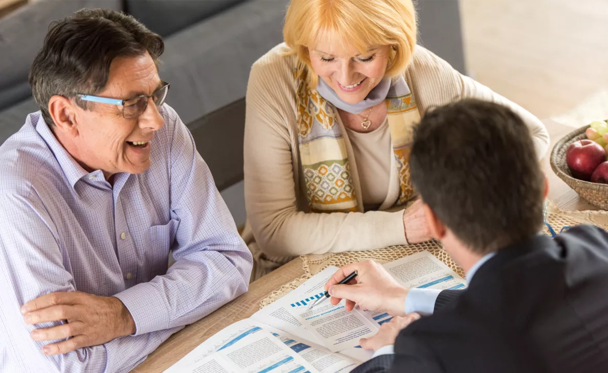  A man and woman working on financial planning with a Financial Advisor
