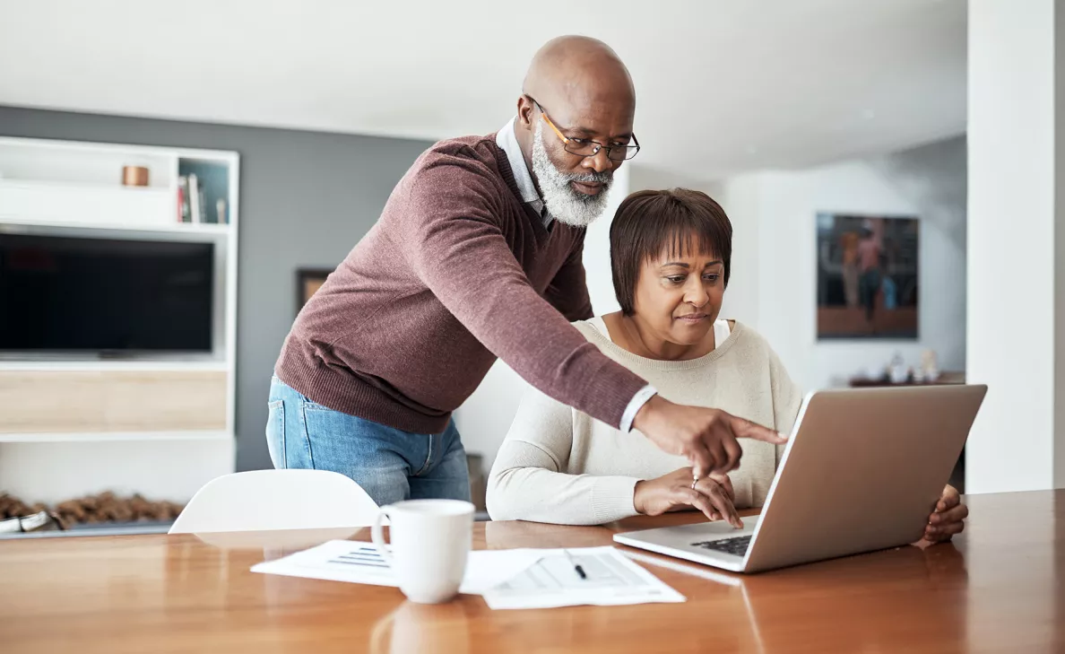 An old couple working on laptop