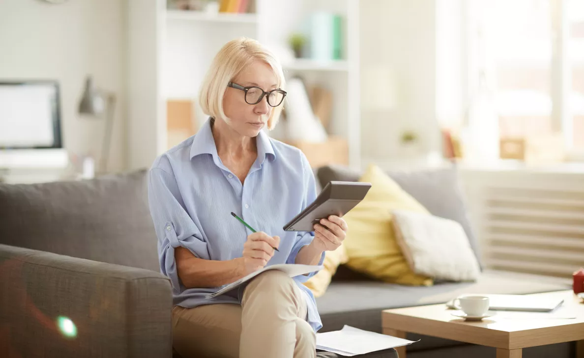 Lady on a couch taking notes