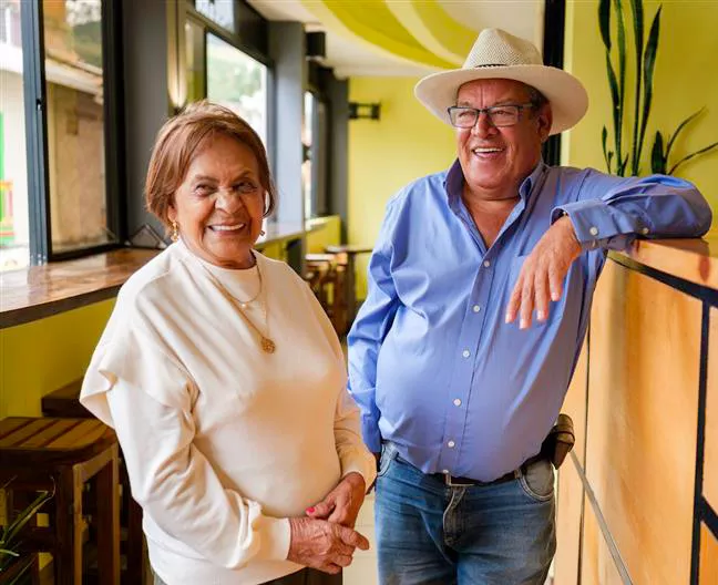 Older couple smiling in a café.