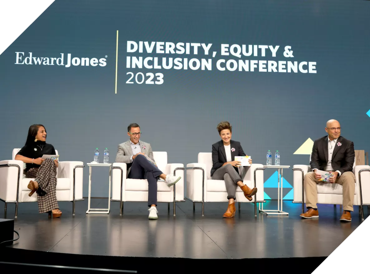  Two men and two women sitting on a DEI conference panel
