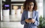 An Edward Jones client is creating a text message on her mobile phone.